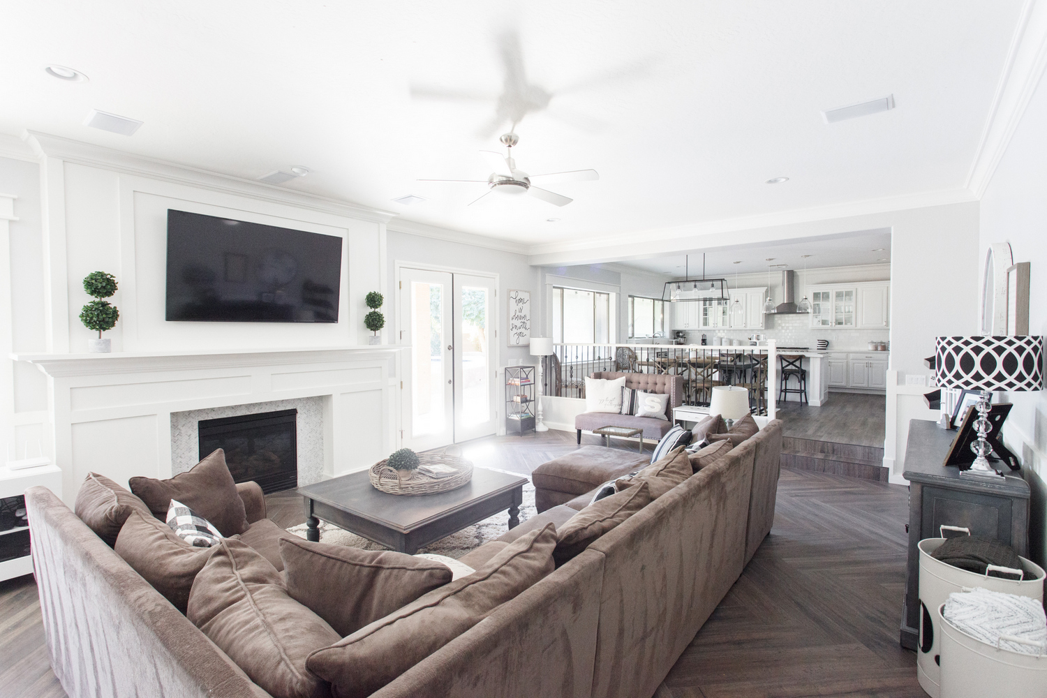 Cozy Family Room with White Paneled Fireplace with TV